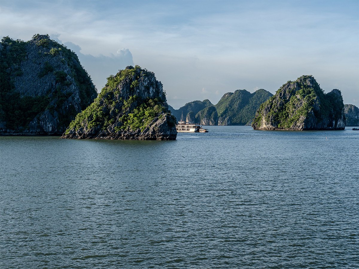 AI-generated illustration of limestone islands and emerald water in Ha Long Bay, Vietnam