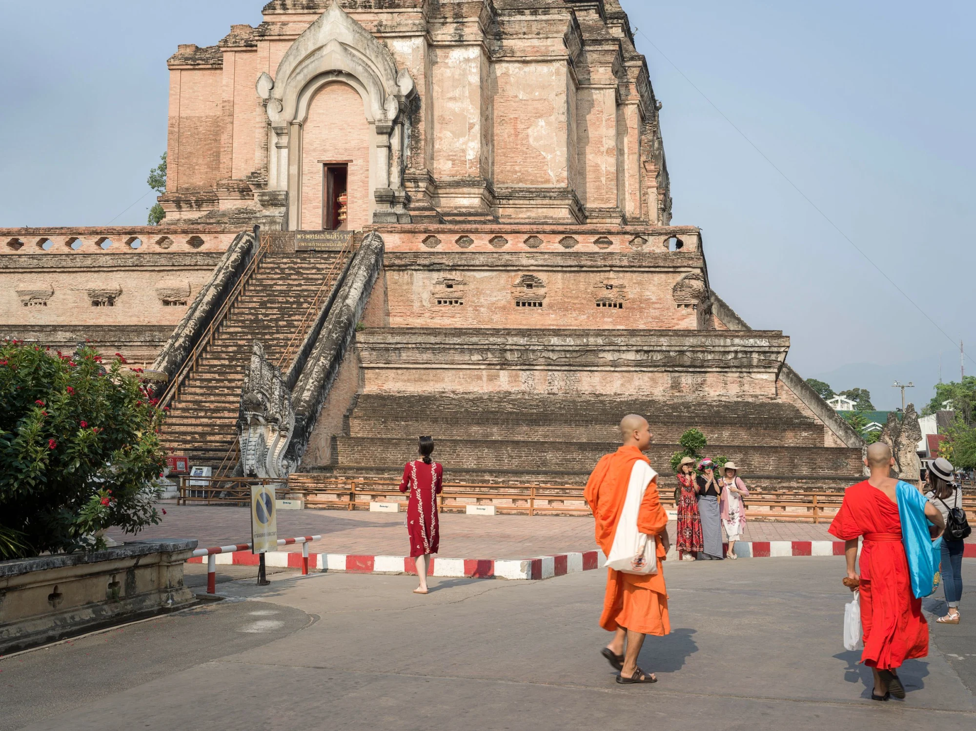 Monks and visitors in front of the brick chedi at Wat Chedi Luang in Chiang Mai