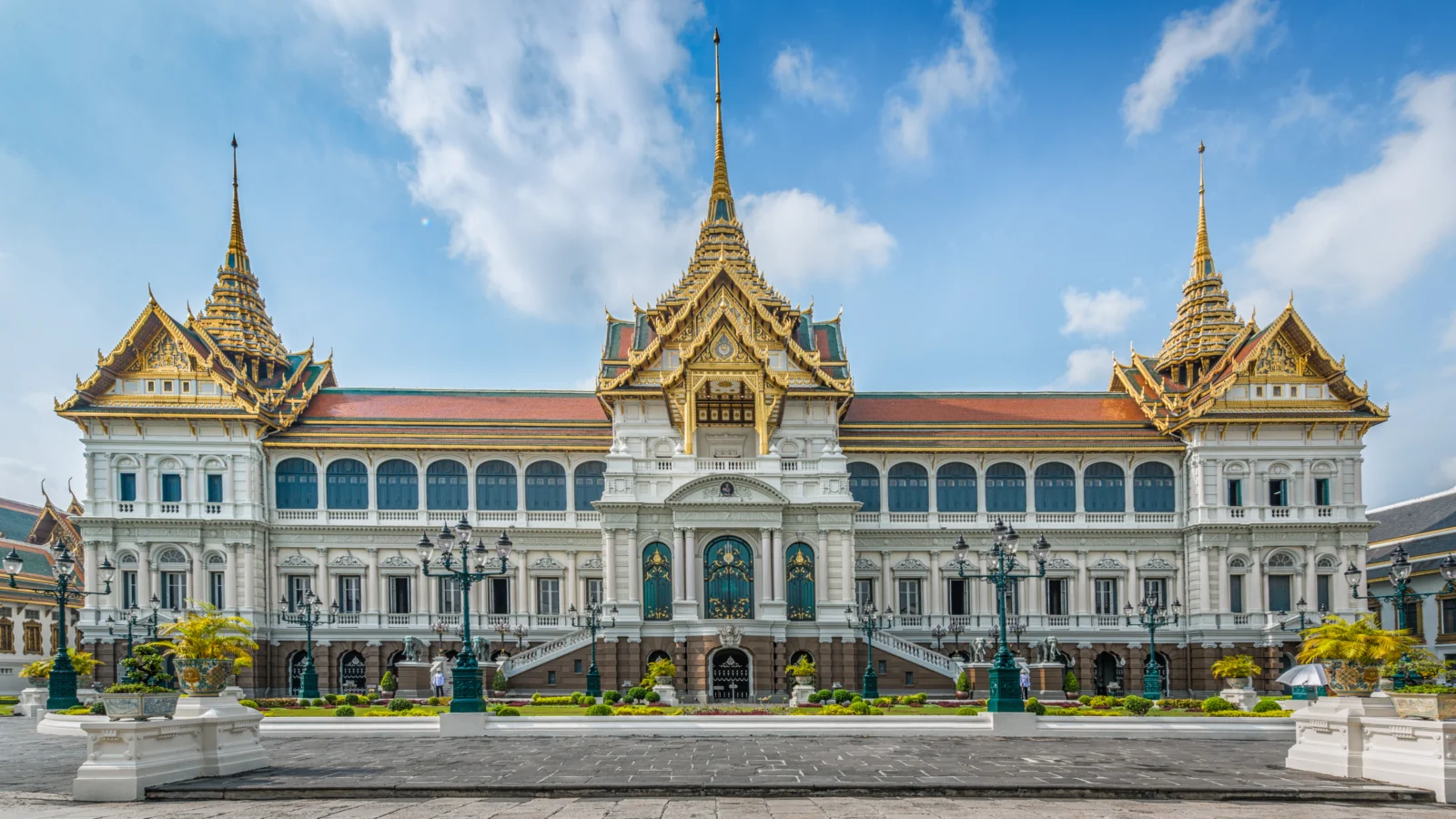 Ornate golden roofs above the Grand Palace facade in Bangkok